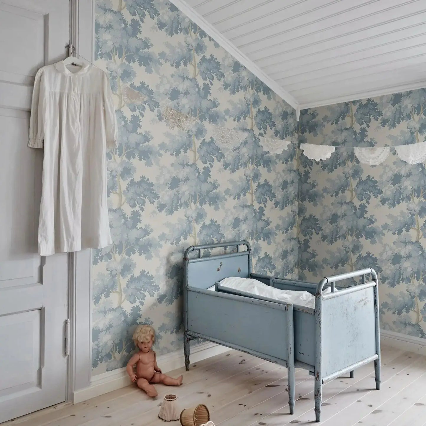 Misty Forest Wallpaper with an antique woven tapestry showing a lush landscape in light blue, Scandinavian Wallpaper Raphael